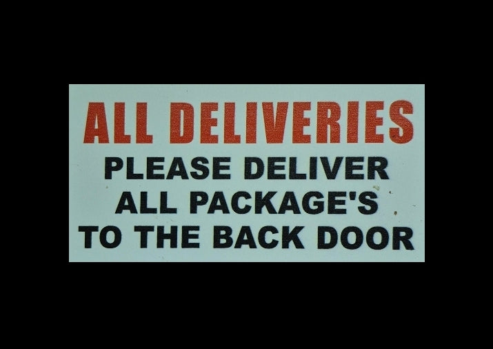 PLEASE DELIVER ALL PACKAGES TO THE BACK DOOR sign